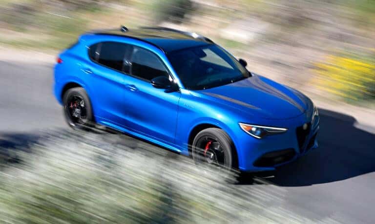 2023 Alfa Romeo Stelvio driving fast with motion blur