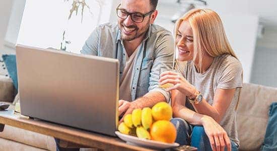 picture of couple looking over their laptop