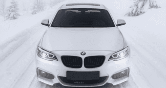 white BMW in snow