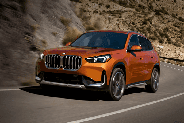 2025 BMW X1 driving along a mountain highway