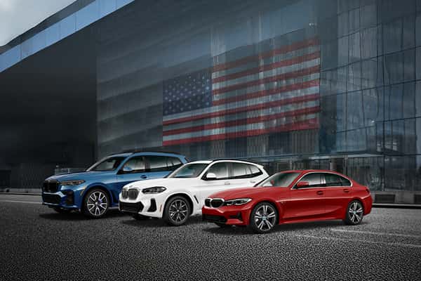 Three BMW vehicles in a lineup outdoors showcasing BMW military discount at Schererville