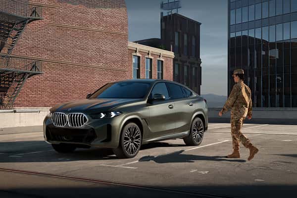 Servicemember in uniform walking to BMW vehicle