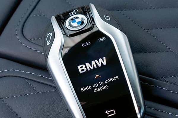 BMW key fob resting on a leather seat