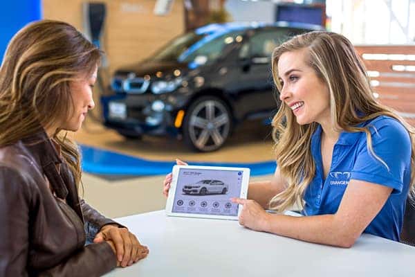 BMW of Schererville sales associate reviewing pricing paperwork with a customer