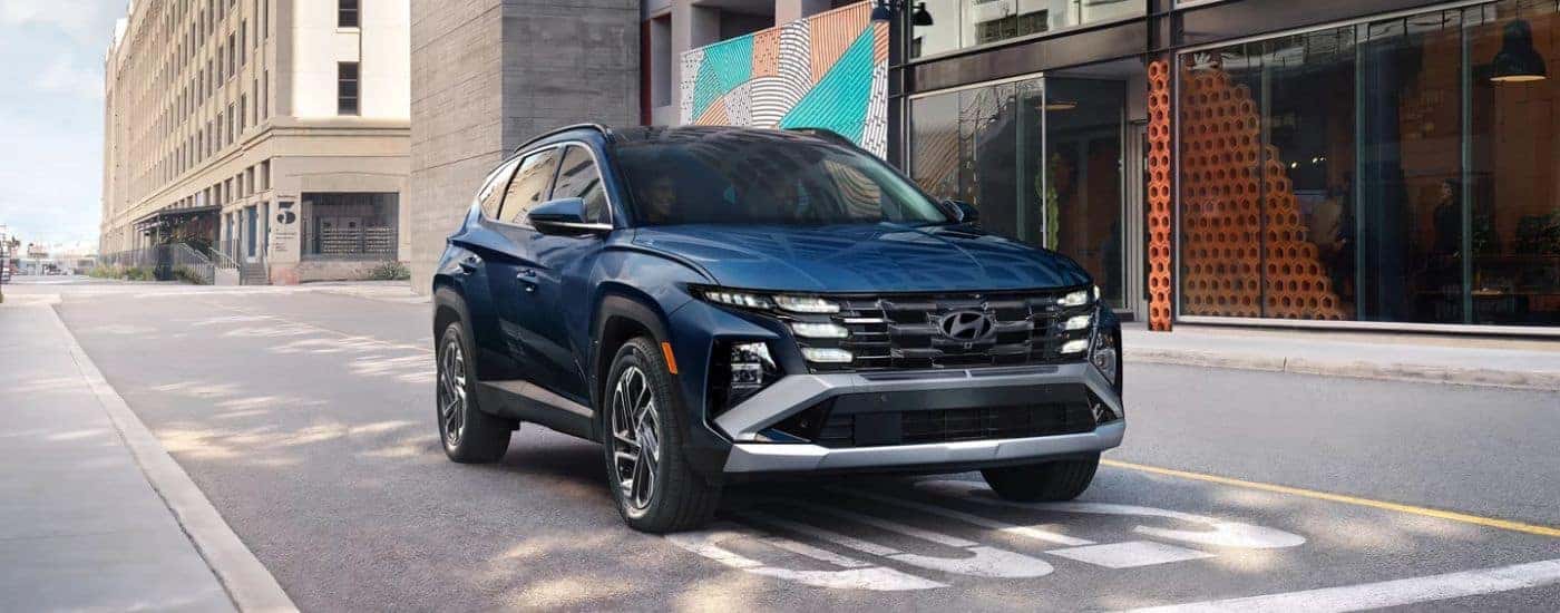 Blue 2026 Hyundai Tucson stopped on the street.