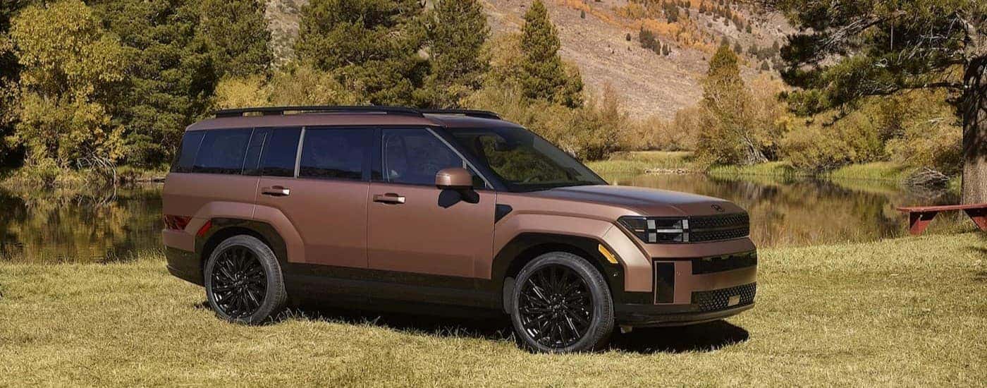 A copper 2026 Hyundai Santa Fe parked on grass.