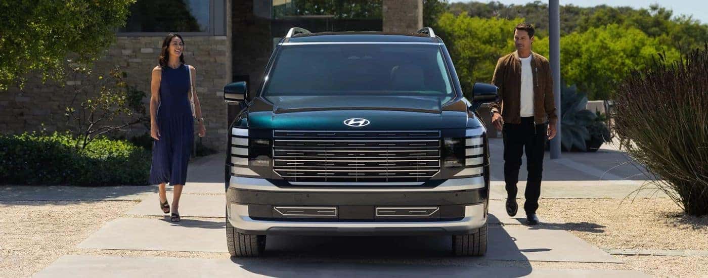 Emerald Green 2026 Hyundai Palisade front view with a couple.