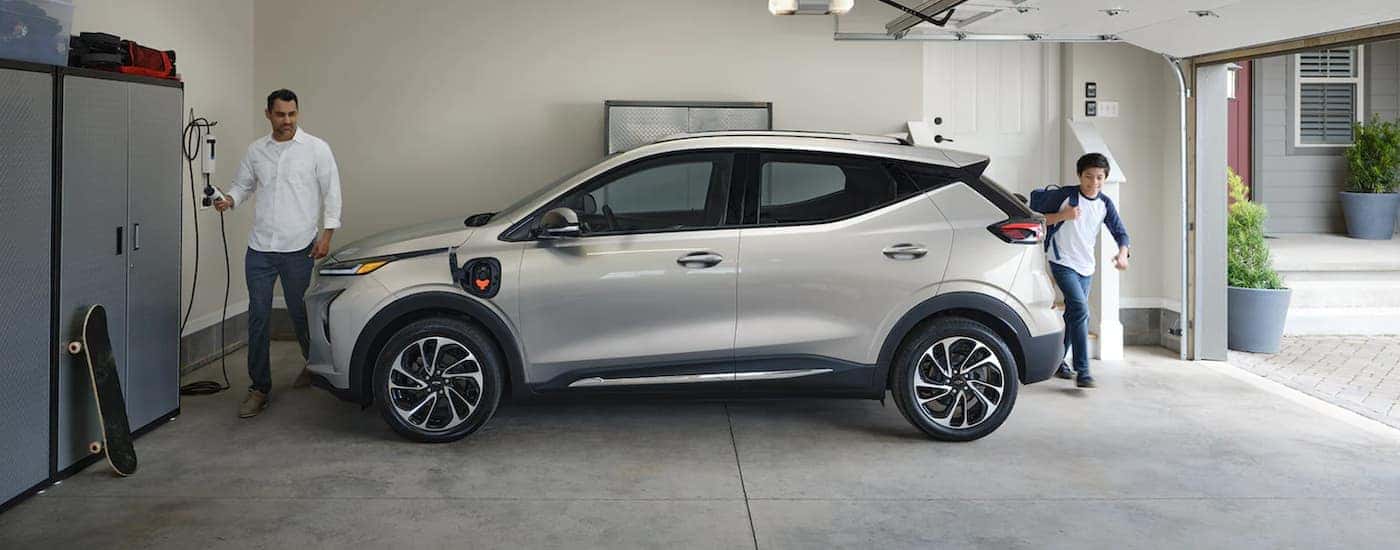 A white 2022 Chevy Bolt EUV is shown from the side parked in a garage.