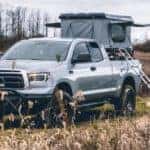 A truck from a Lexington used truck dealership is being used to hold a tent.
