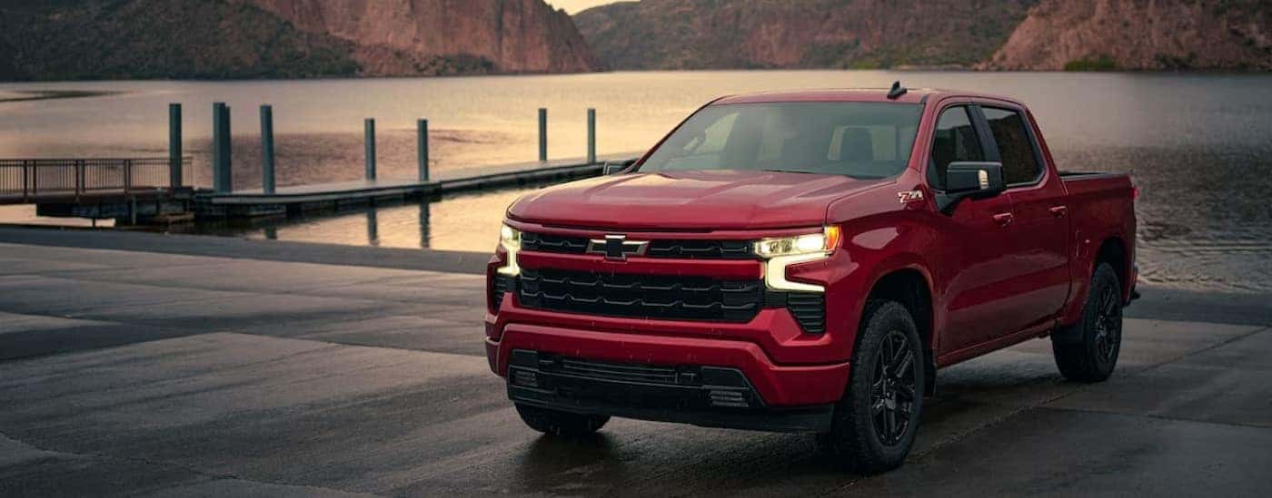 A red 2024 Chevy Silverado 1500 RST is shown parked near a dock after viewing a Chevy Silverado 1500 for sale near Bardstown.