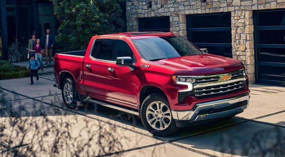 A red 2024 Chevy Silverado 1500 Z71 parked on a driveway.