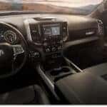 Interior view of a 2026 RAM 1500 featuring a black dashboard, steering wheel, and center touchscreen display.