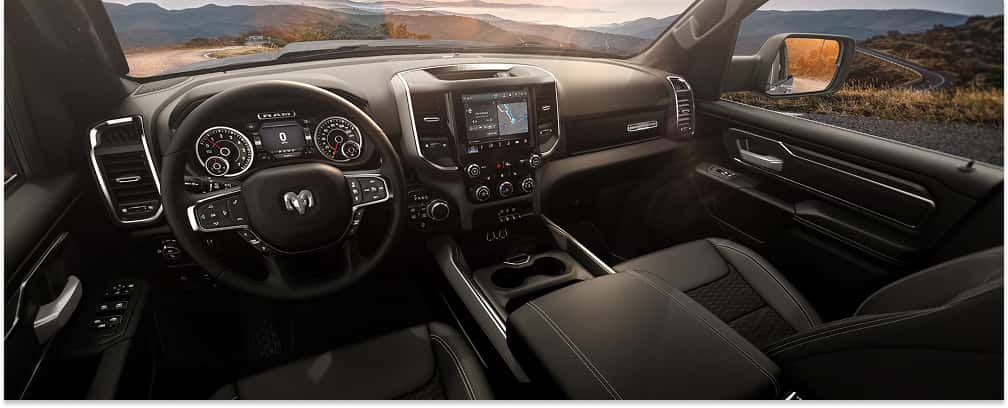 Interior view of a 2026 RAM 1500 featuring a black dashboard, steering wheel, and center touchscreen display.