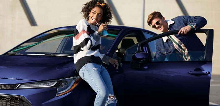 Compare the 2021 Toyota RAV4 vs. the 2021 Honda CR-V at Team Toyota of Glen Mills | Youths enjoying their 2022 Corrolla in sunny weather