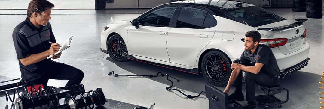 Everything You Need to Know about Your Car Battery at Halterman's Toyota | Two mechanics prepare to work on car