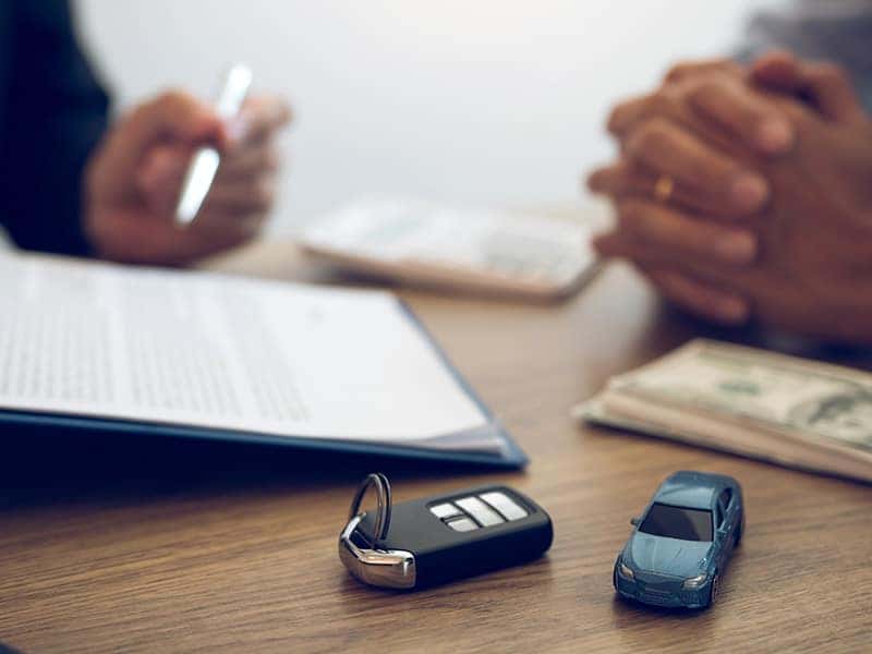 Vehicle Warranty Information at Halterman's Toyota in East Stroudsburg | Customer & Finance Advisor Talk Over Paperwork