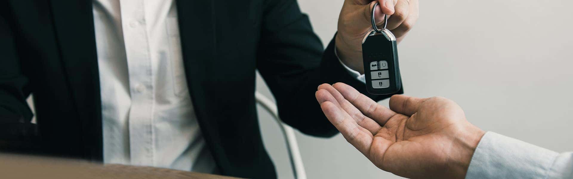 Vehicle Warranty Information at Halterman's Toyota in East Stroudsburg | Customer Receiving Car Keys from Finance Advisor