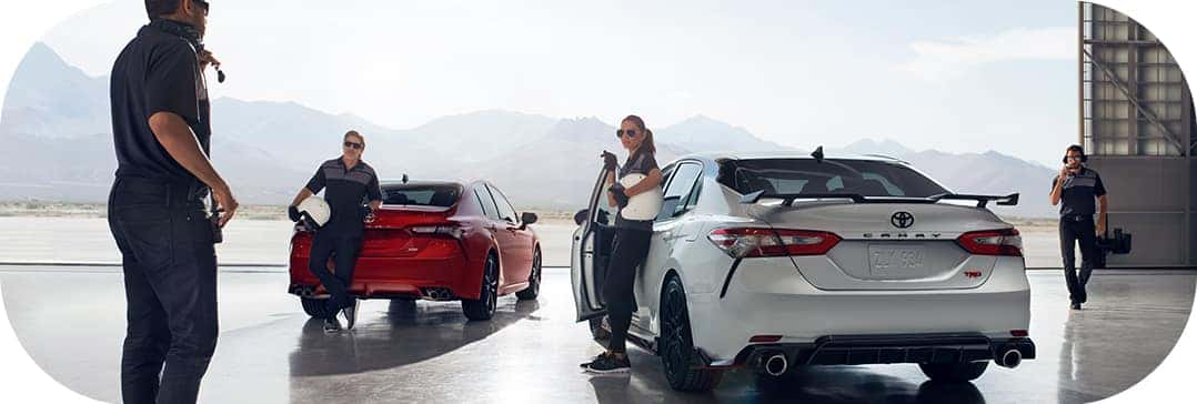 Defining APR at Halterman's Toyota in East Stroudsburg, PA | Red and white Camry TRD parked in hanger with professional drivers