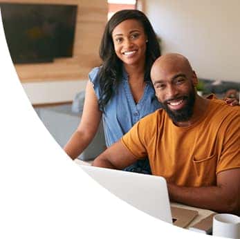 Defining APR at Halterman's Toyota in East Stroudsburg, PA | Couple happily sit at laptop in kitchen