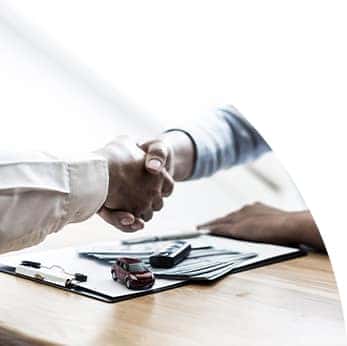 Defining APR at Halterman's Toyota in East Stroudsburg, PA | Sales man shakes hand with customer over table