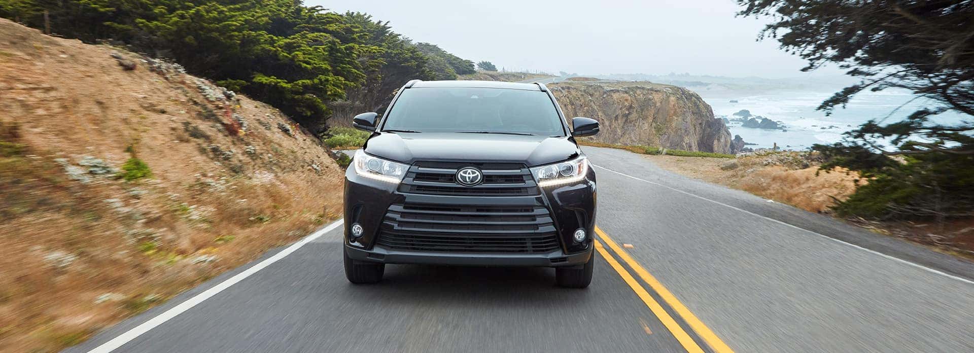 Things to Check When Buying a Used Car | Halterman's Toyota in East Stroudsburg, PA | Used Black 2018 Toyota Highlander Driving On Road Past Water