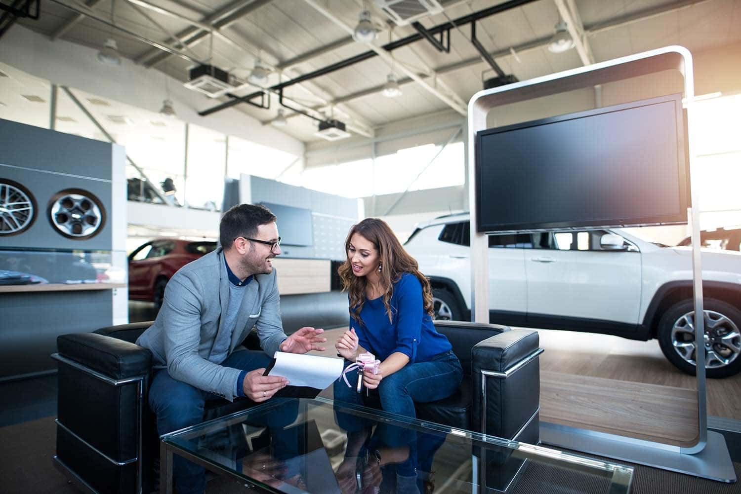 Leasing versus Buying a Toyota at Halterman's Toyota in East Stroudsburg, PA | Salesman helping customer buy a new vehicle