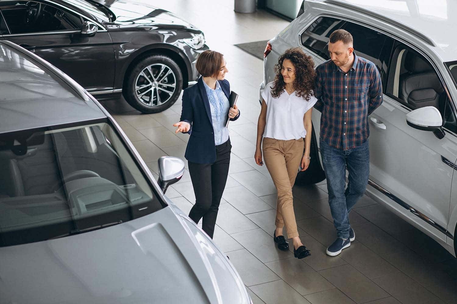 Leasing versus Buying a Toyota at Halterman's Toyota in East Stroudsburg, PA | Saleswoman talking with customers in the showroom