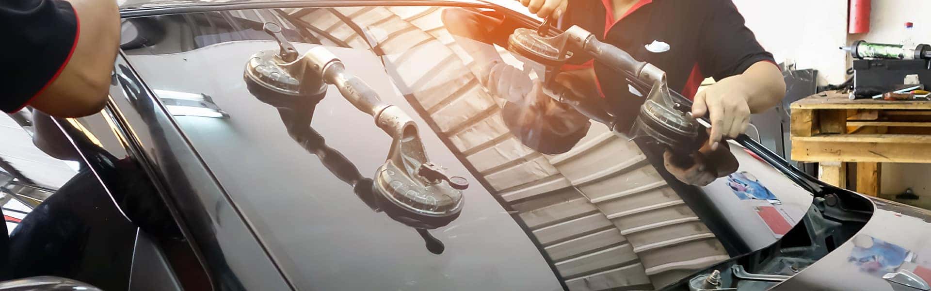 Why You Shouldn’t Drive Around with a Chipped Windshield at Halterman's Toyota in East Stroudsburg, PA | Two Service Advisors Replacing Windshield on Vehicle