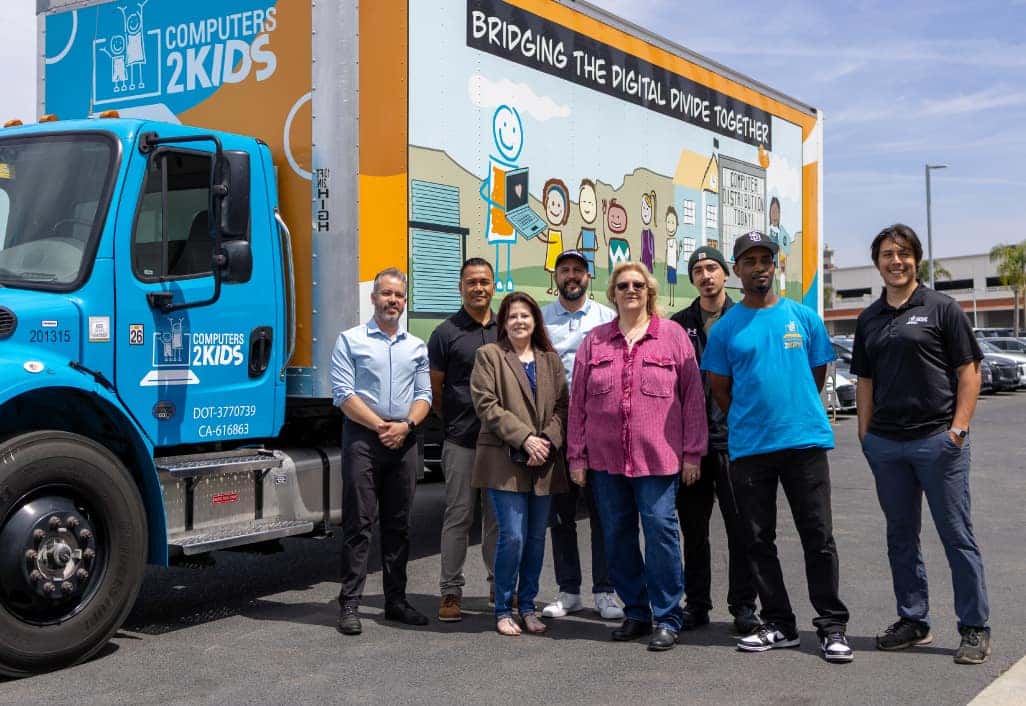 Hoehn Team members stand with the Computers 2 Kids Team