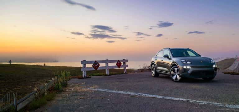 2027 Porsche Macan 4 Electric parked on the North County coast at dusk