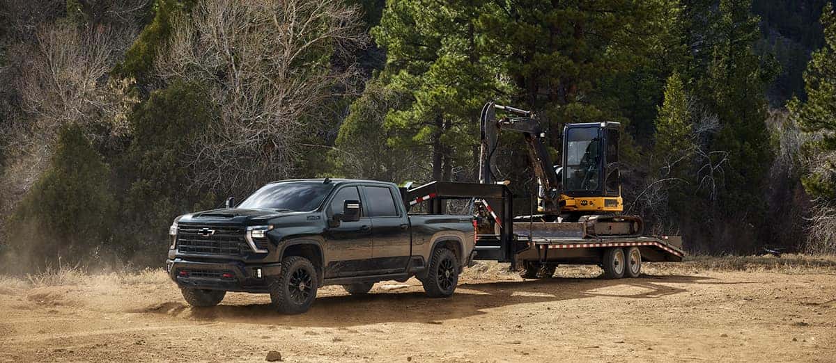 2026 Chevrolet Silverado HD Crew Cab 4x4 hauling heavy commercial equipment