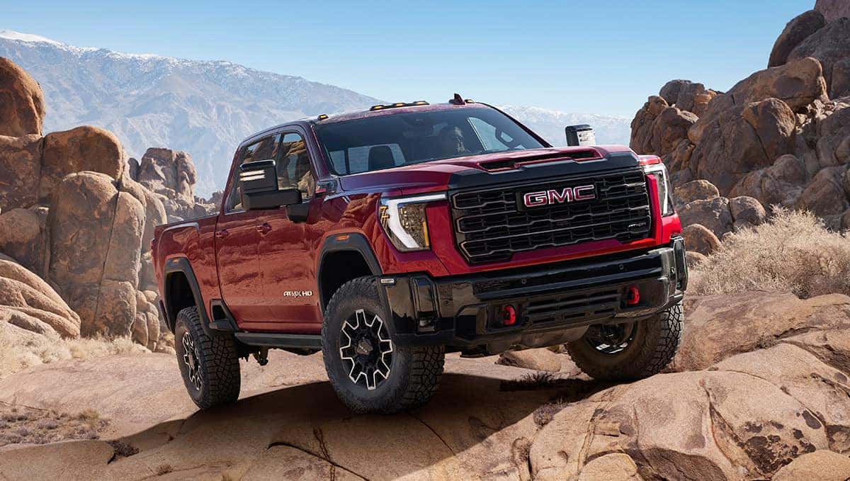 2026 GMC Sierra HD Crew Cab exterior profile in outdoor mountain terrain