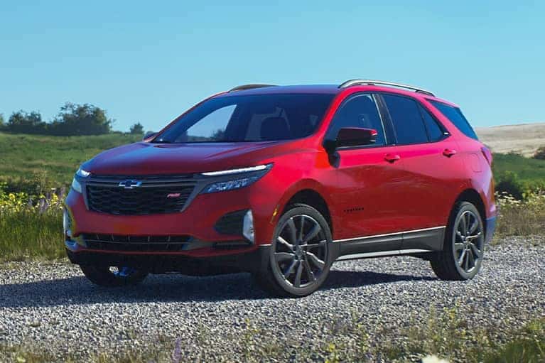 2023-Red-Chevrolet-Equinox-parked-on-a-gravel-road-in-a-field