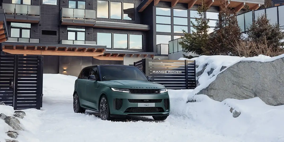 2025 Land Rover Defender 90 driving on a rugged dirt road in the mountains
