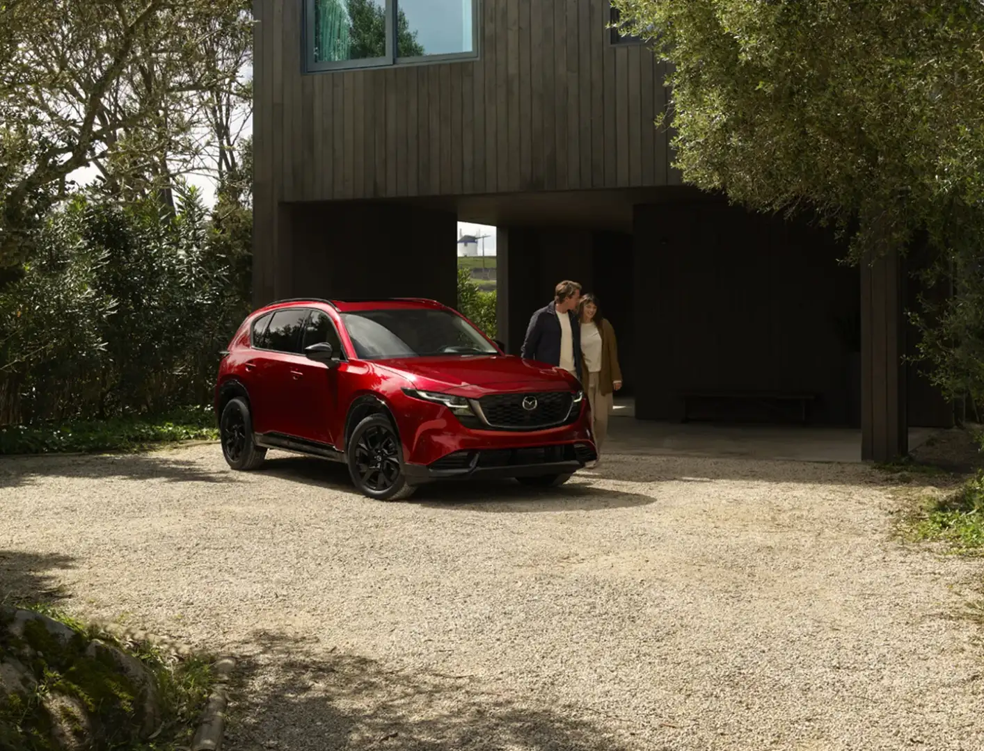 A Mazda CX-90 parked in a driveway at home