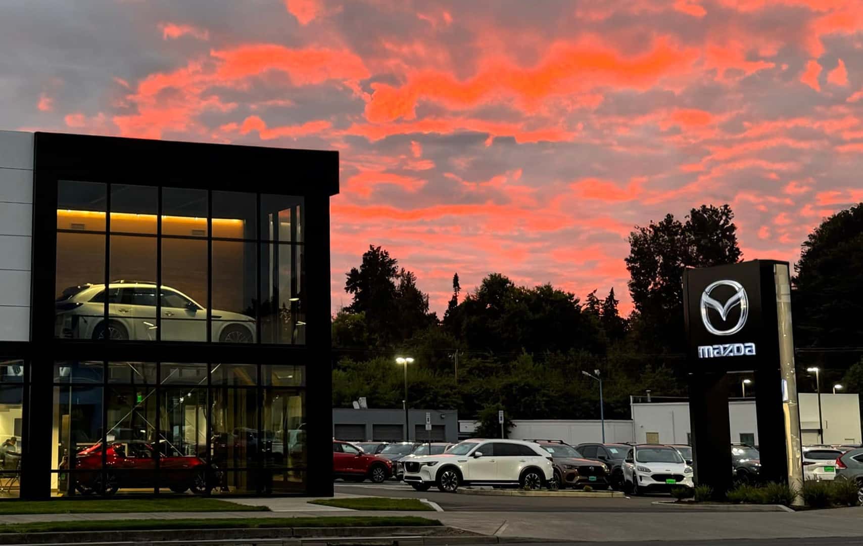 Mazda of Gladstone dealership at sunset