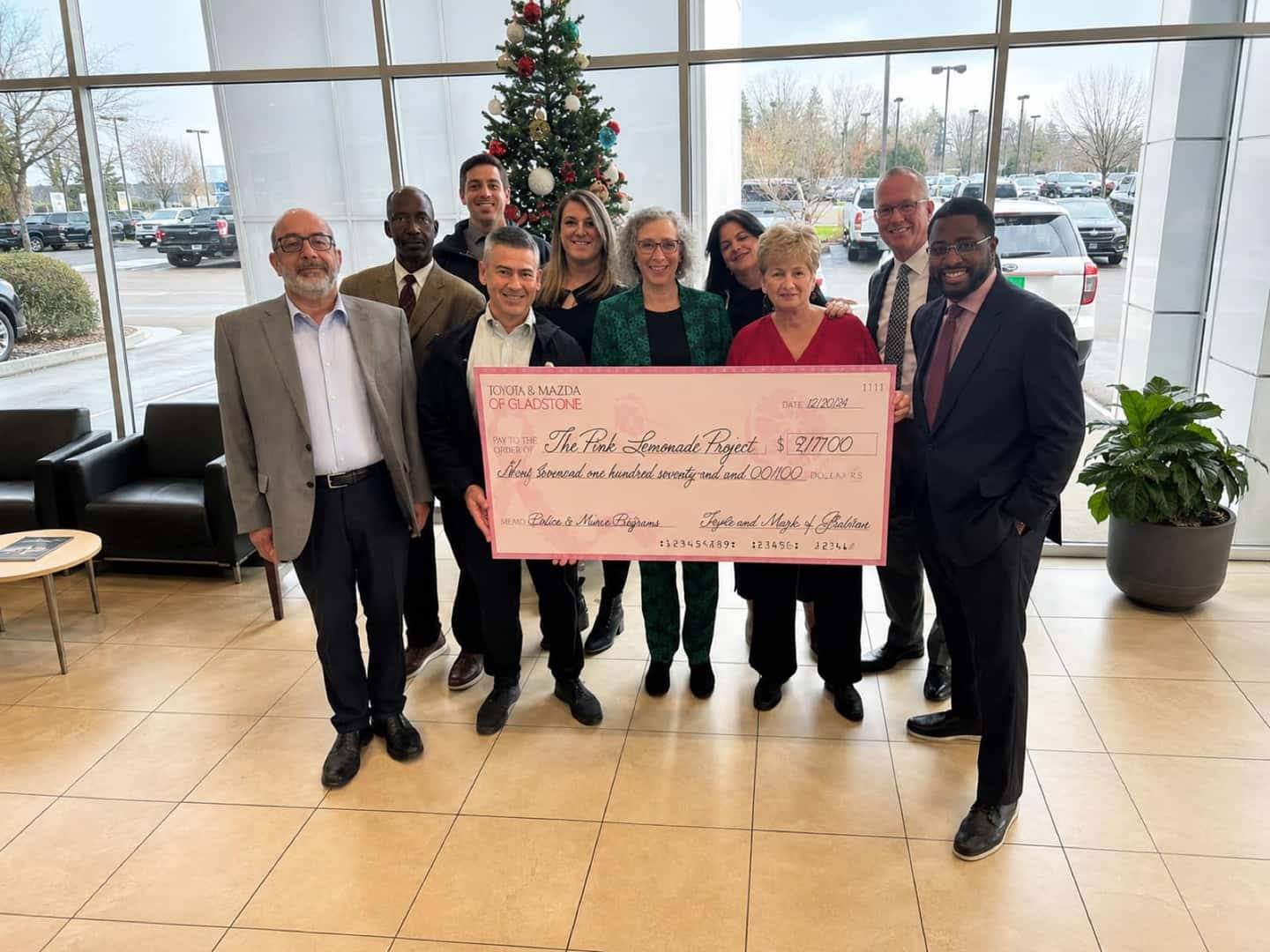 Mazda of Gladstone team members presenting a donation check to the Pink Lemonade Project