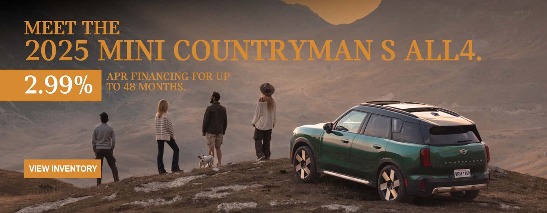 MINI Countryman parked with a family of 4 and their dog on a snow hill across a valley in the mountains.
