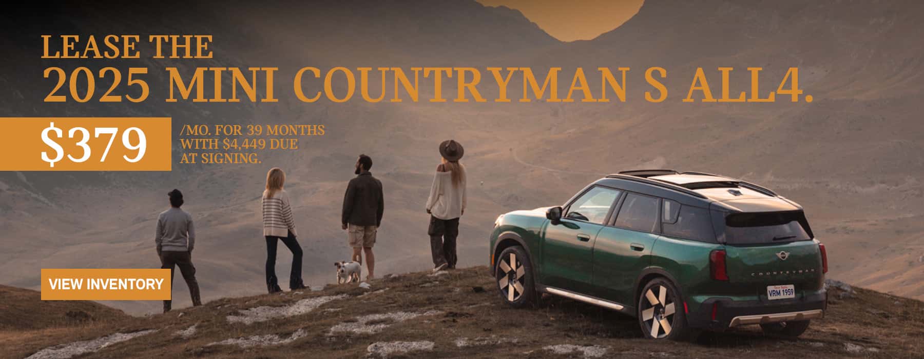 MINI Countryman parked with a family of 4 and their dog on a snow hill across a valley in the mountains.