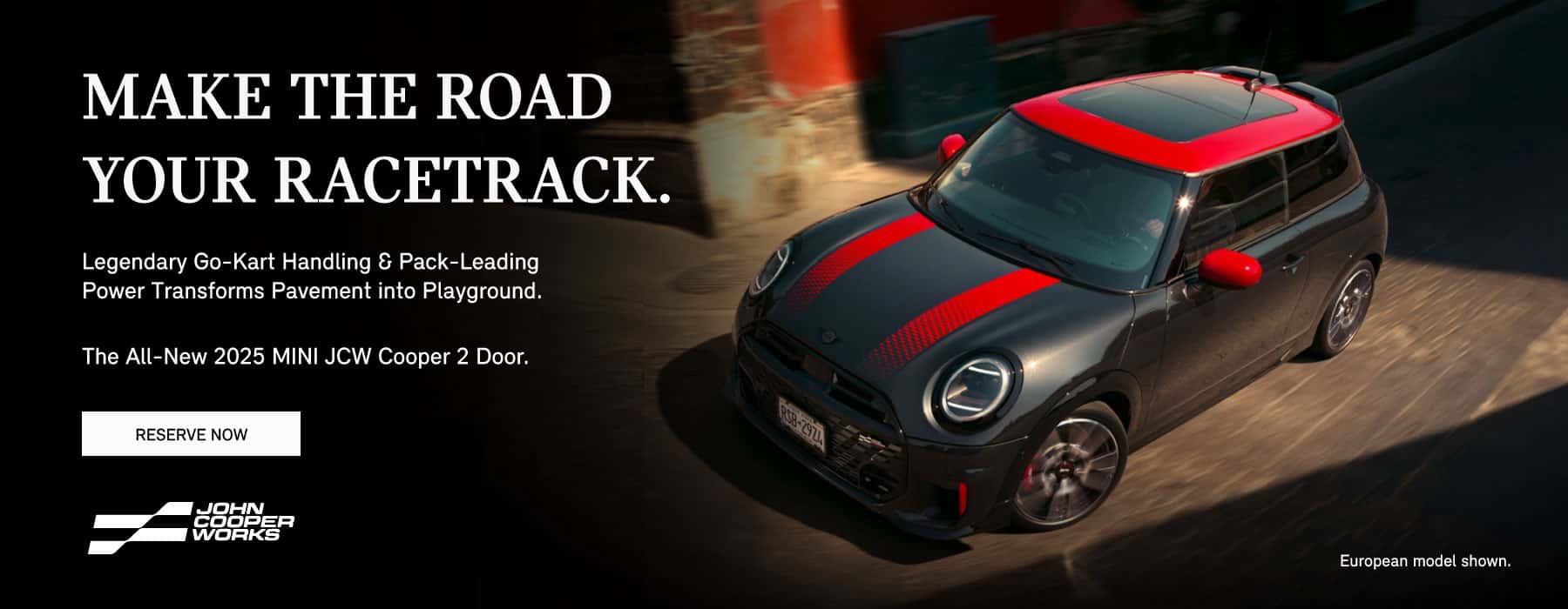 Black and red MINI JCW 2 Door driving through a city street.