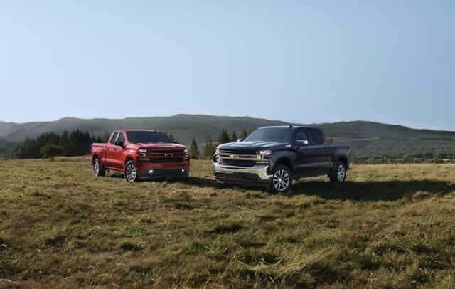 Three Chevrolet Cars lined up outside.