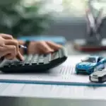 Person calculating loan budget NewPortMotors