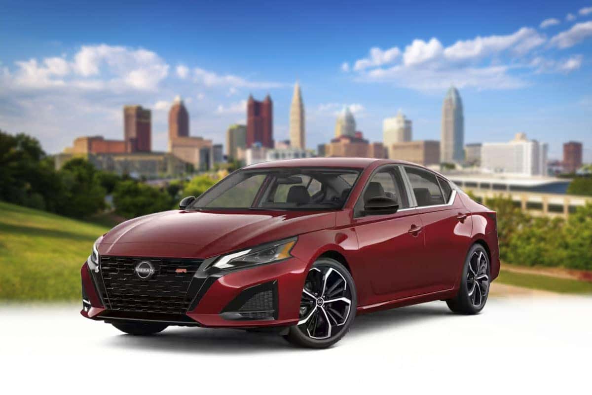 Front three-quarter view of a 2026 Nissan Altima in Scarlet Ember Tintcoat red near Cleveland Ohio