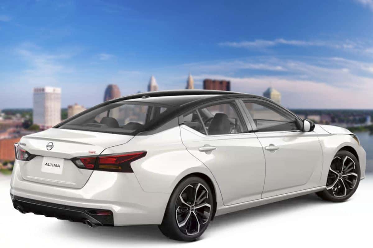 Rear three-quarter view of a 2026 Nissan Altima in Two-Tone Pearl White TriCoat