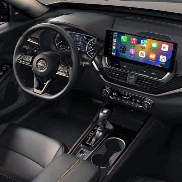 Nissan touchscreen showing Apple CarPlay navigation and app icons