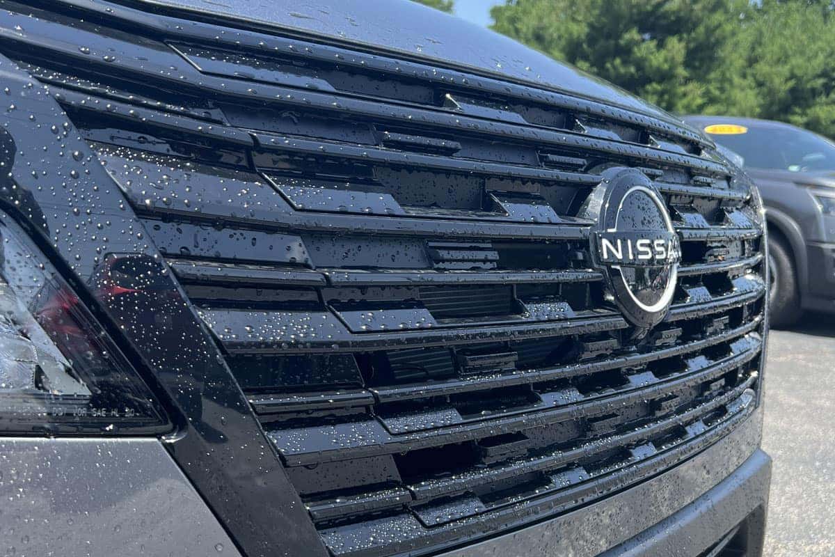 Close-up of the gloss black V-Motion grille on the 2026 Nissan Rogue Dark Armor Edition