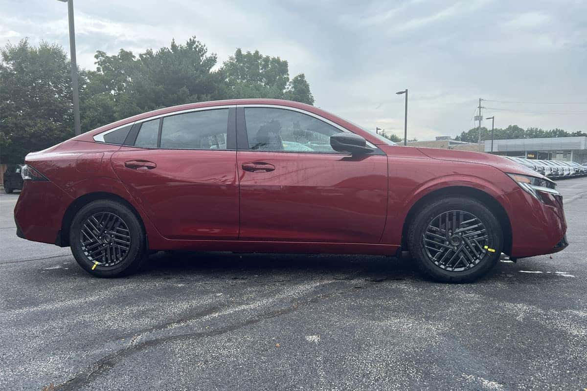 2027 Nissan Sentra Scarlet Ember Tintcoat passenger side profile near Cleveland, Ohio