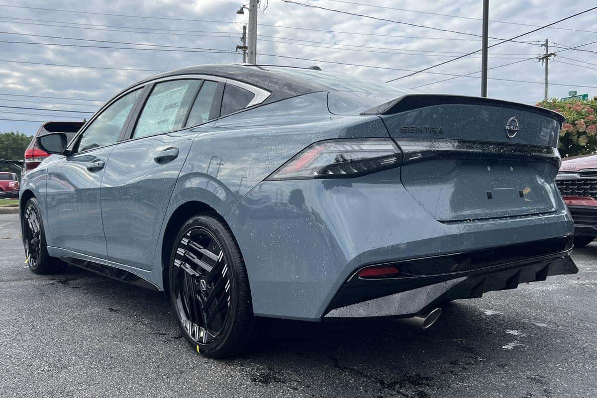 Rear driver side view of the 2027 Nissan Sentra Two-Tone Atlantic Gray Metallic with Black Roof exterior color near Cleveland, Ohio