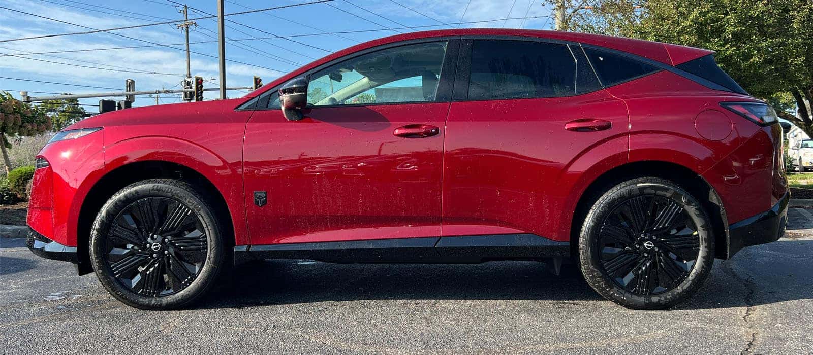 Driver side view of the red 2027 Nissan Murano in Scarlet Ember Tintcoat at Nissan of North Olmsted