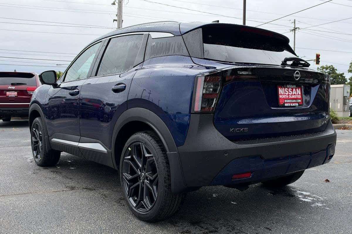 Driver-side rear three-quarter view of a 2027 Nissan Kicks in Deep Blue Pearl at Nissan of North Olmsted